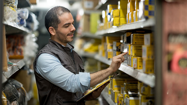 Man checks inventory in warehouse